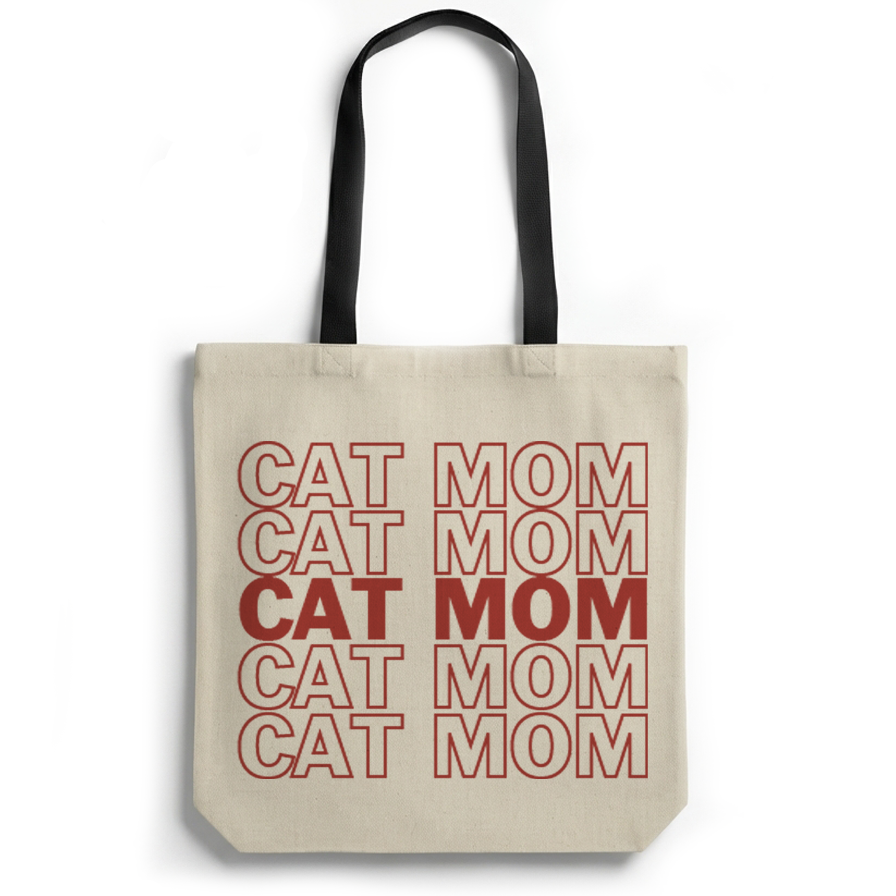 Tote bag with 'CAT MOM' text printed in red on a beige background