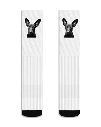 Two socks with a dog's face design on a white background