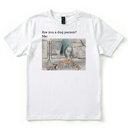 White t-shirt with a graphic of a person and dogs, text 'Are you a dog person? Me:', on a white background.