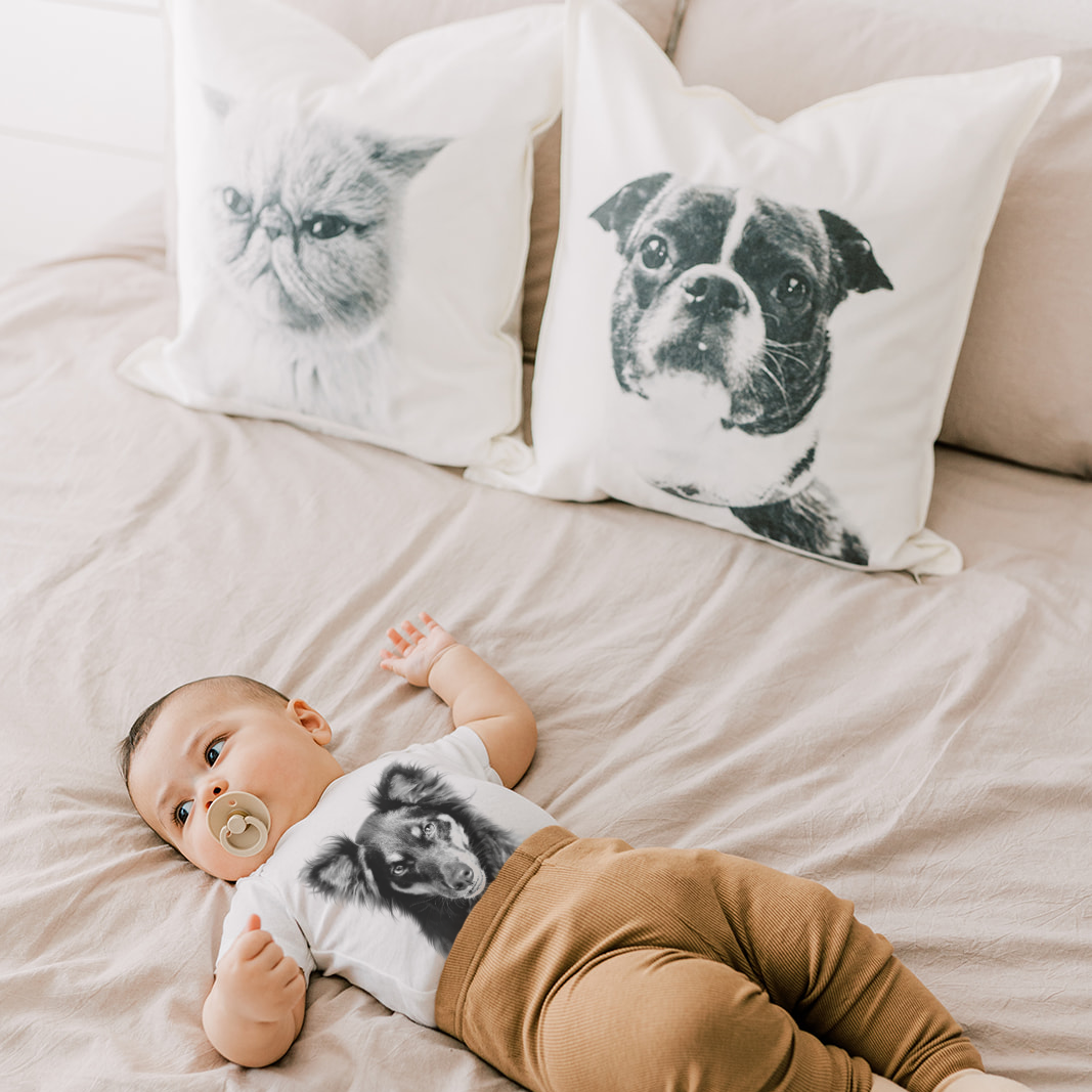 Baby lying on a couch with pillows featuring dog illustrations