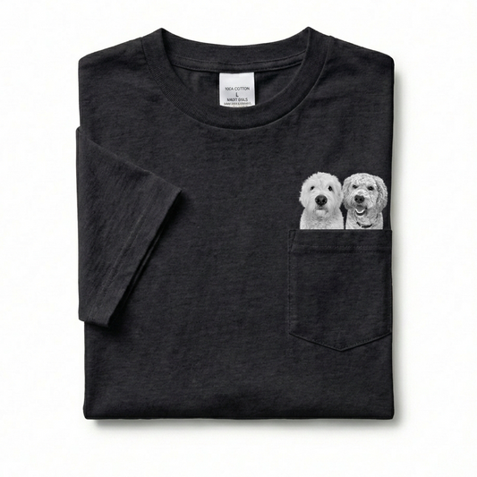 Folded black t-shirt with a pocket featuring two dog illustrations on a white background