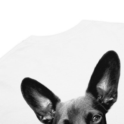 A close-up of a black-and-white dog's ears and eyes printed on a white T-shirt against a white background.