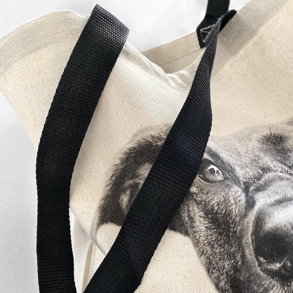 Detail view of canvas tote bag texture black handles printed image dog 